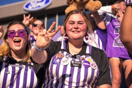P.A.N.K.U.S. students smiling in game-day overalls